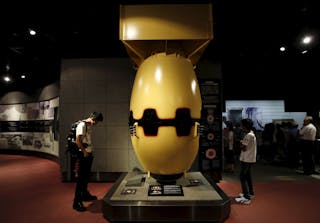 Visitors look at a mock Nagasaki-type atomic bomb named "Fat Man" at the Nagasaki Atomic Bomb Museum in Nagasaki