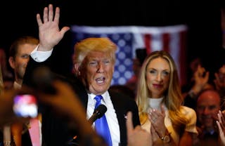 Republican U.S. presidential candidate and businessman Donald Trump waves after speaking to supporters following the results of 