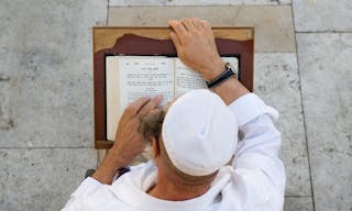 JERUSALEM, ISRAEL - OCT 08, 2014: An jewish man is reading in the torah near the wailing wall in Jerusalem