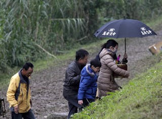 Family members of the passengers on the crashed TransAsia Airways plane Flight GE235 leave the site after a Daoist ceremony in N