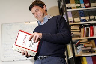 Thomas Piketty, French economist and academic, poses in his book-lined office at the French School for Advanced Studies in the S