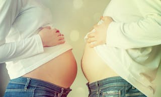 man and pregnant woman is showing their bellies