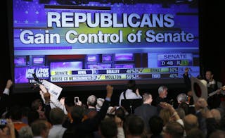 Republican supporters cheer as a giant TV screen displays the results of the Senate race in the U.S. midterm elections in Denver