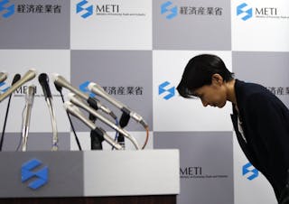 Japan's Economy, Trade and Industry Minister Yuko Obuchi bows as she arrives for a news conference at her ministry in Tokyo