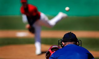 Baseball player wearing uniform throwing baseball