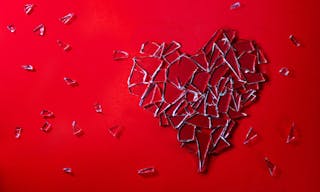 Glass love heart on red background