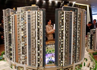 Potential buyer looks at model of Riva, a property development by Sun Hung Kai Properties, in Hong Kong