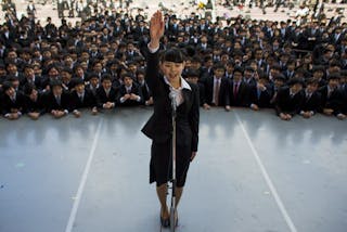 A Japanese college graduate publicly promises that she will do her best in trying to find work during a job-hunting rally at an 