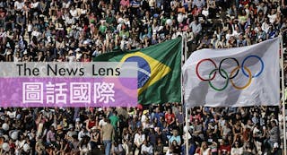 The Brazilian and Olympic flags fly over the Panathenaic Stadium during the handover ceremony of the Olympic Flame to the delega