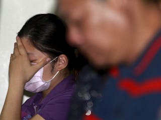 A family member of a victim injured in a fire at the Formosa Fun Coast water park reacts at Taipei Veterans General Hospital in 