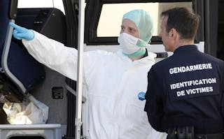 French investigators talk together outside a Gendarmerie mobile forensic van in Seynes-les-Alpes near the crash site of a German