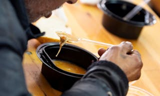 Sofia, Bulgaria - 14 February 2019: Elderly man eats warm soup with bread in a kitchen with free food for poor and homeless peop