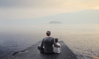 Father and son sitting on a pier over a lake — Photo by olly18