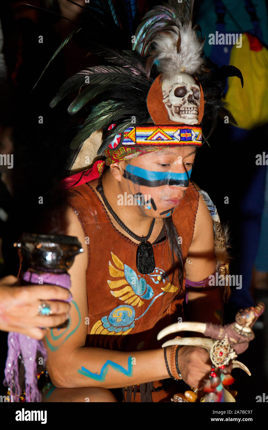 A shaman emulates a spiritual performance during the halloween celebration.Halloween is celebrated in October 31 and “The day of the dead” or Día de los Muertos in Spanish is celebrated after, on Nov. 2.  This party is celebrated mostly in Mexico and some parts of Central and South America. It´s an opportunity to remember and celebrate the lives of departed loved ones, In Madrid, every year, the Mexican population celebrate its famous religious party in the 'Day of the dead'. This party took place in 'Cebada Market' Stock Photo