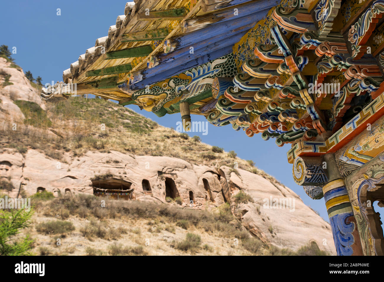 Decorated roofs and buddhist caves at the Monastery of Mati Si, Gansu, China Stock Photo