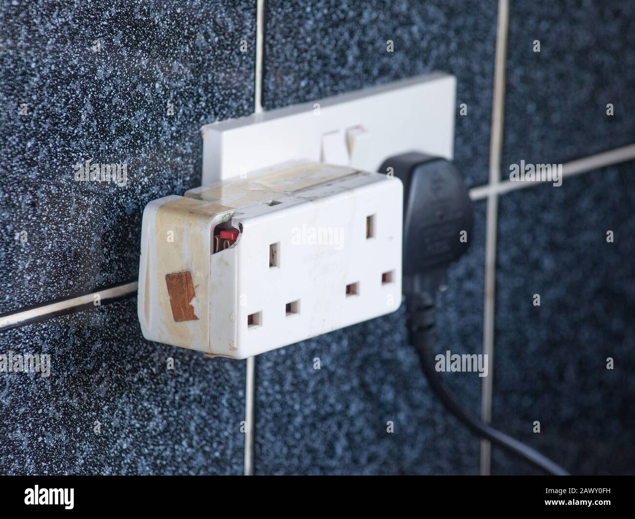 Close up of a broken and damaged extension socket. Stock Photo