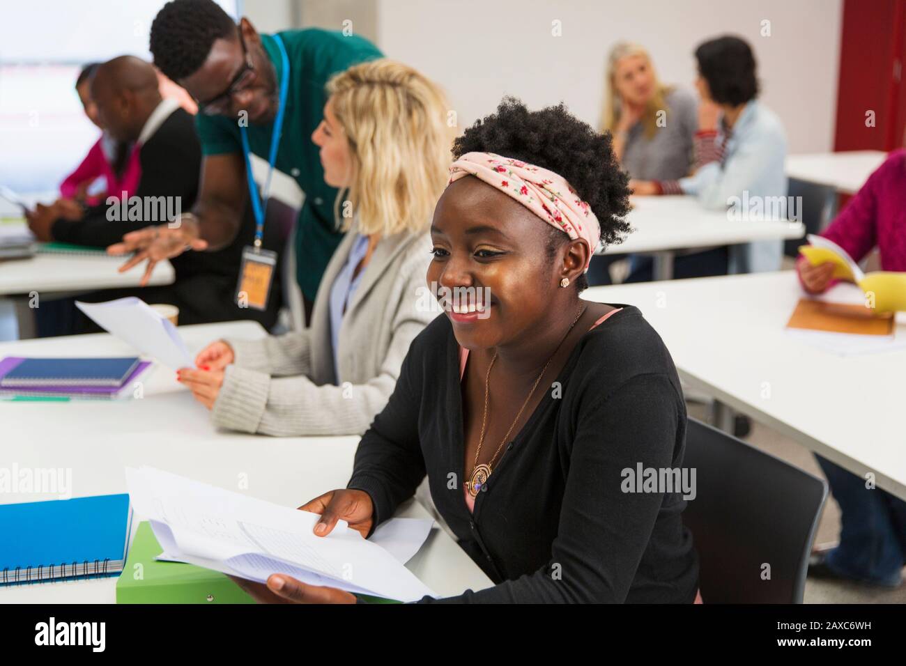 Smiling, confident young female community college student in classroom Stock Photo