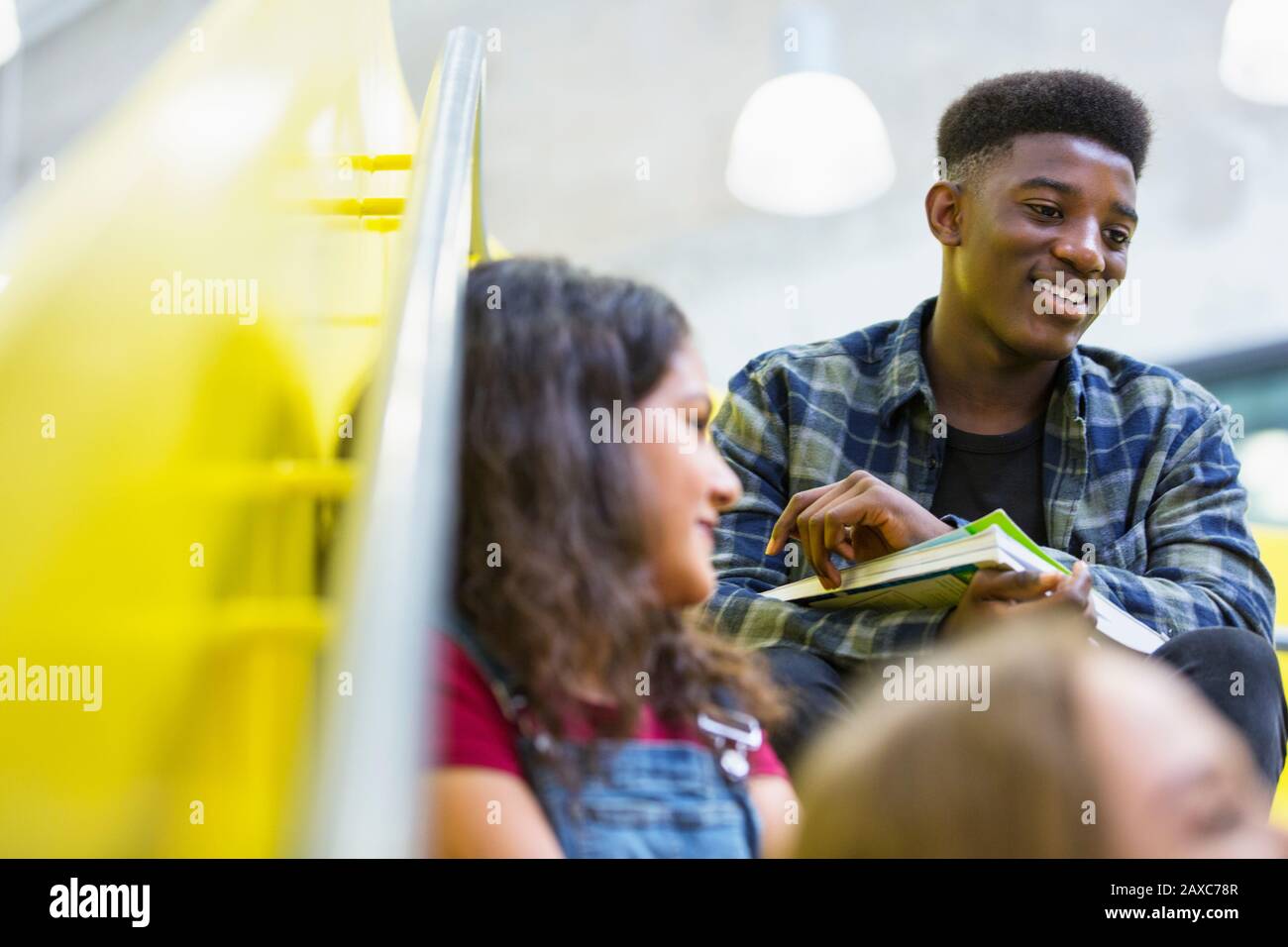 Junior high students talking on stairs Stock Photo