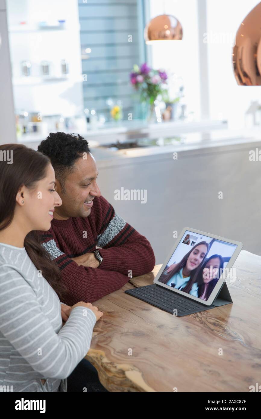 Parents video conferencing with daughters at digital tablet Stock Photo