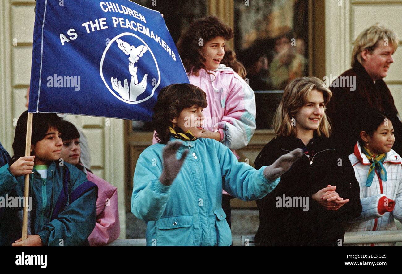 West German children display a banner as they welcome East German visitors driving through Checkpoint Charlie.  The East Germans are taking advantage of relaxed travel restrictions to visit the West. Stock Photo