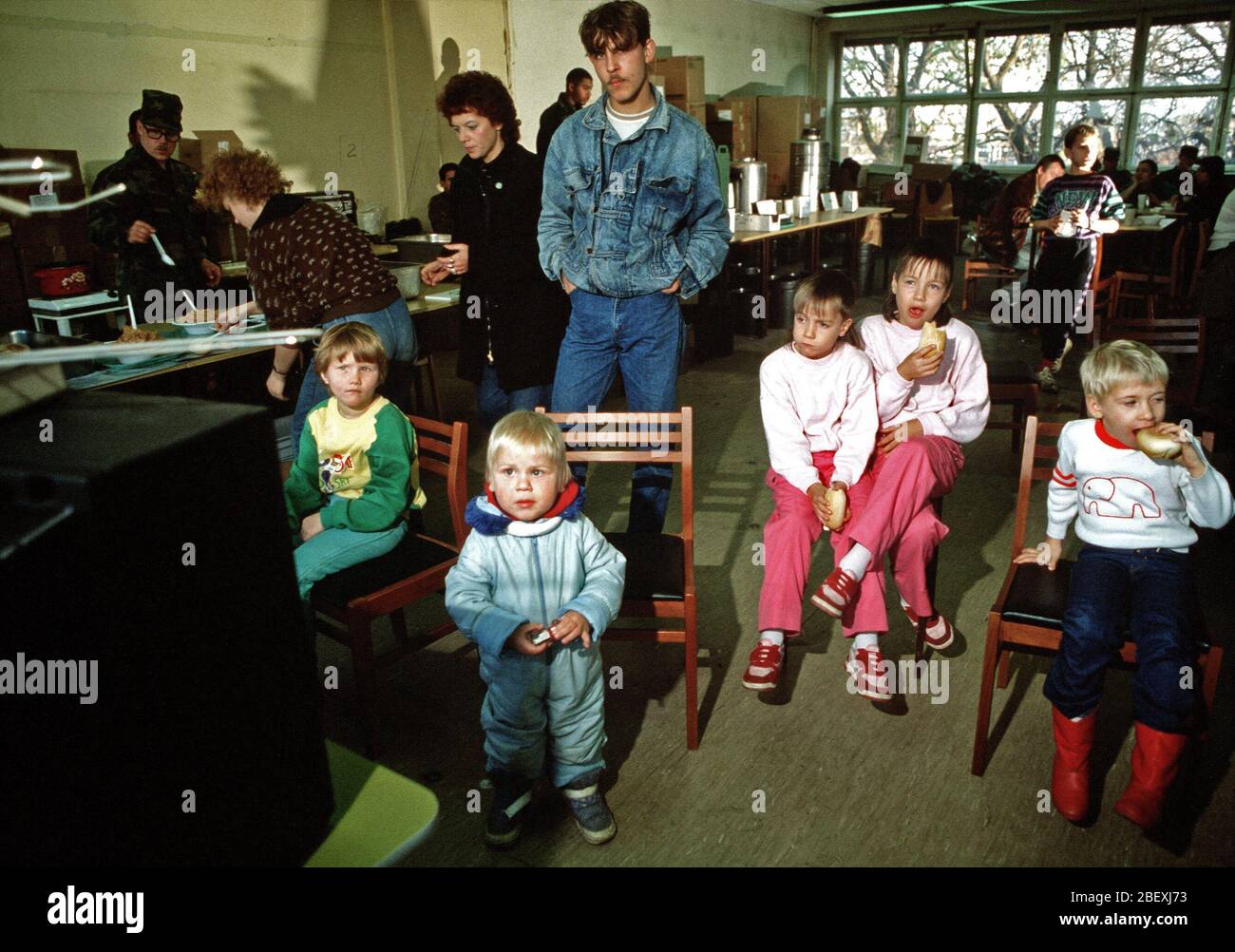 East German children enjoy a snack at the refugee center in West Berlin. Stock Photo