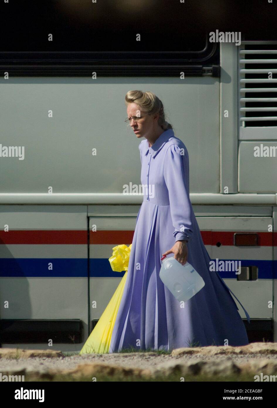 San Angelo, Texas:  April 8, 2008: A young woman wearing a handmade traditional dress carries belongings from a bus to cabins at the Fort Concho historic site where members of the Yearning for Zion polygamist sect are being housed while in state custody following allegations of child abuse at the sect's compound near El Dorado Texas. ©Bob Daemmrich Stock Photo