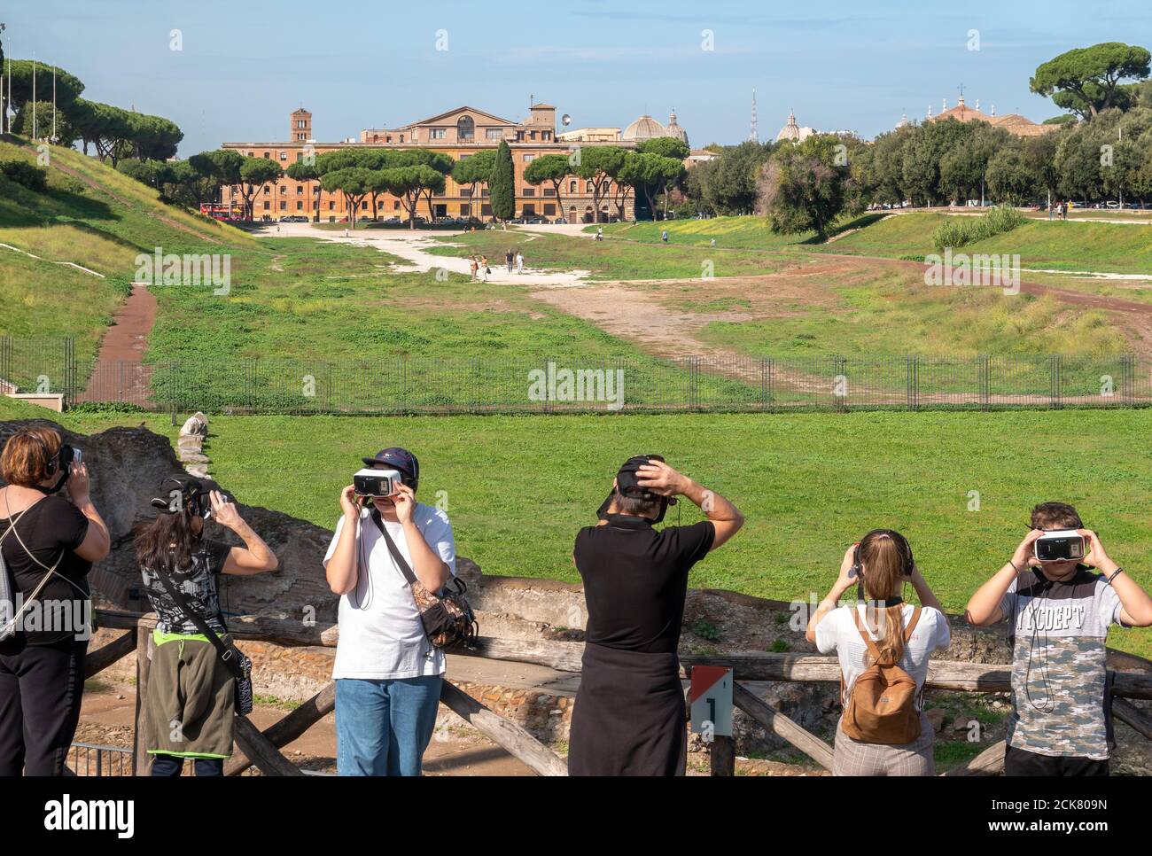 Rome Circus Maximus group of tourists wearing VR augmented reality headsets viewing the virtual 3d reconstruction of the ruins of Ancient Rome Stock Photo