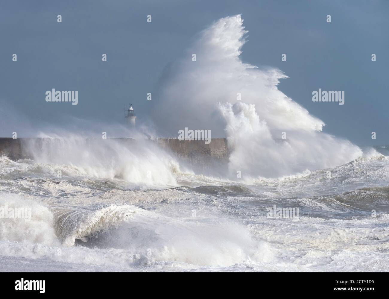 Storm waves breaking over the harbour arm and lighthouse at Newhaven, East Sussex, UK Stock Photo