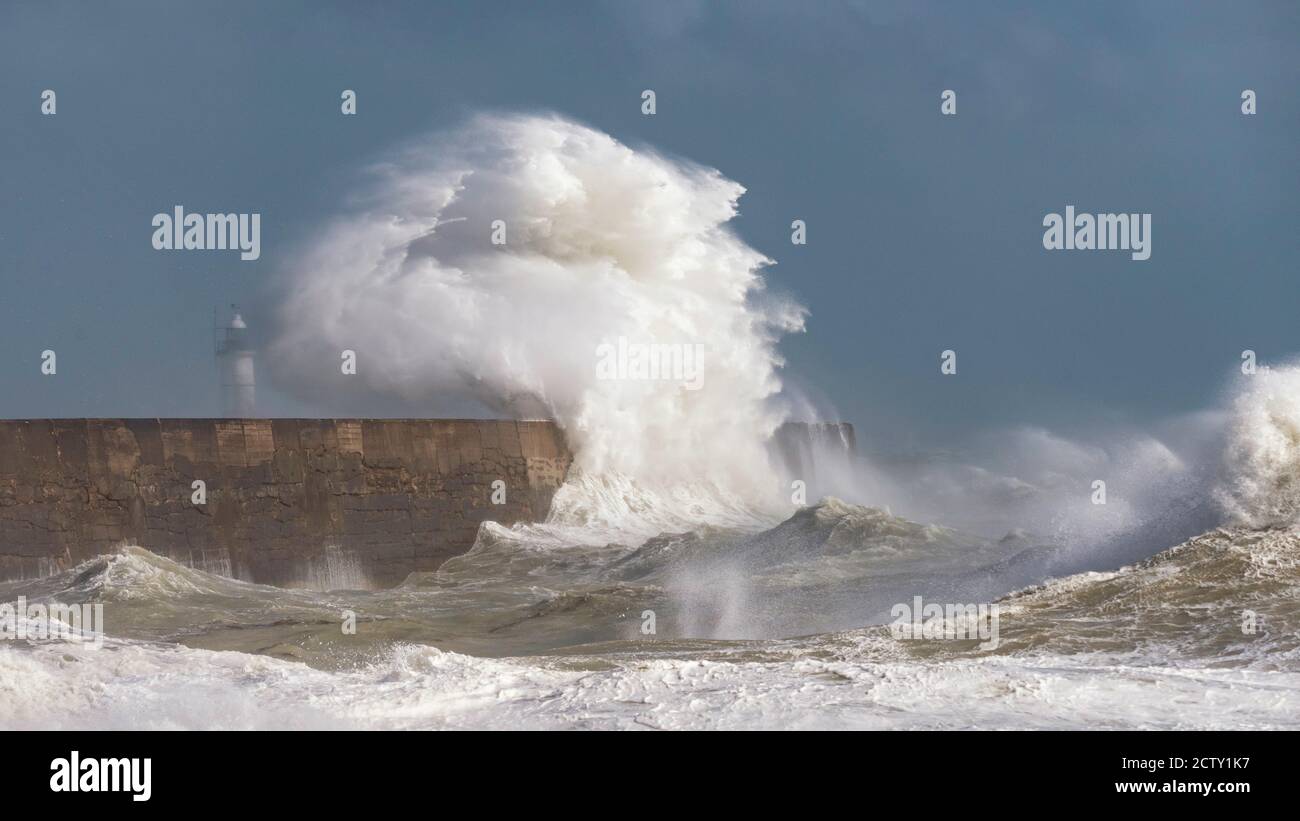 Storm waves breaking over the harbour arm and lighthouse at Newhaven, East Sussex, UK Stock Photo