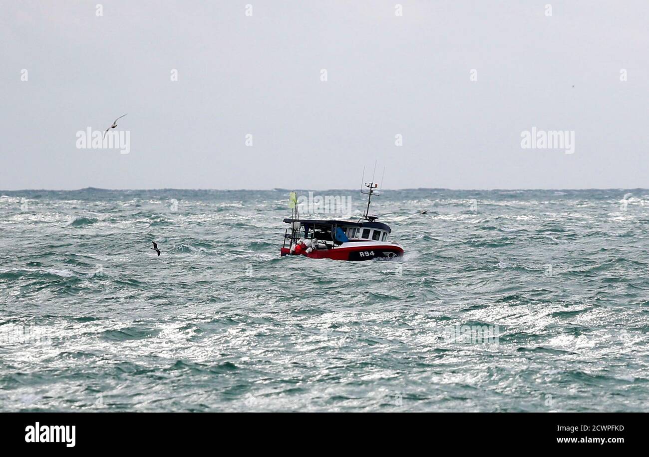 A fishing boat makes its way back to Newhaven harbour, East Sussex. Stock Photo