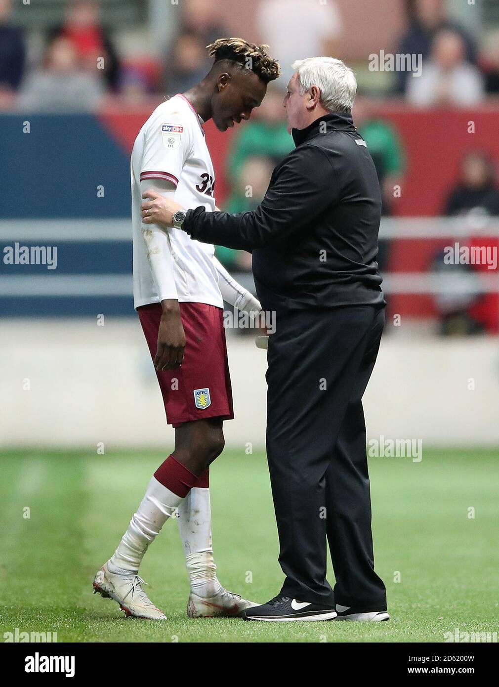 Aston Villa's Tammy Abraham speaks with manager Steve Bruce after his substitution towards the end of the game Stock Photo