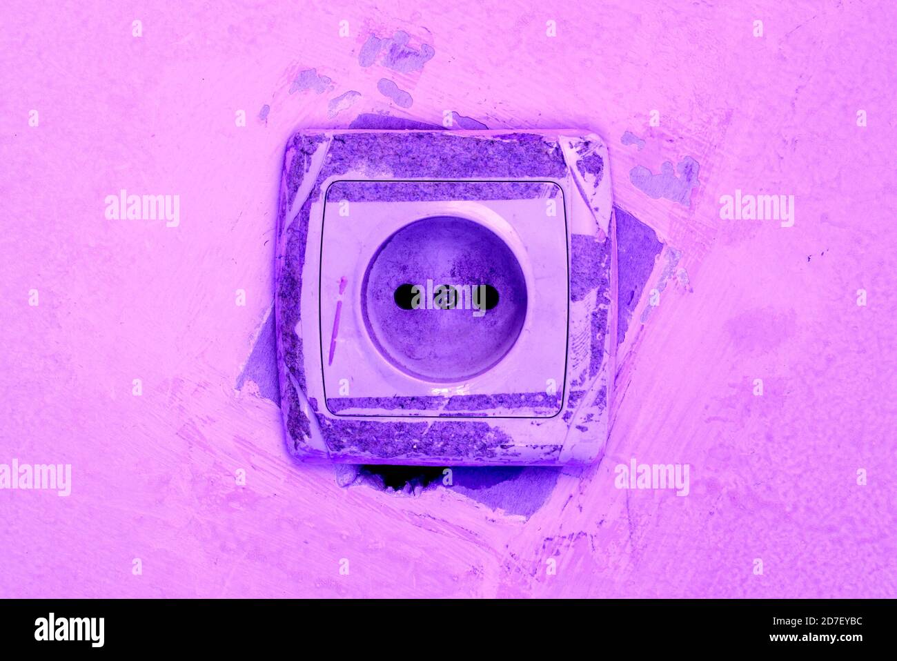 An electrical socket with diry spots in pyrple color. Stock Photo