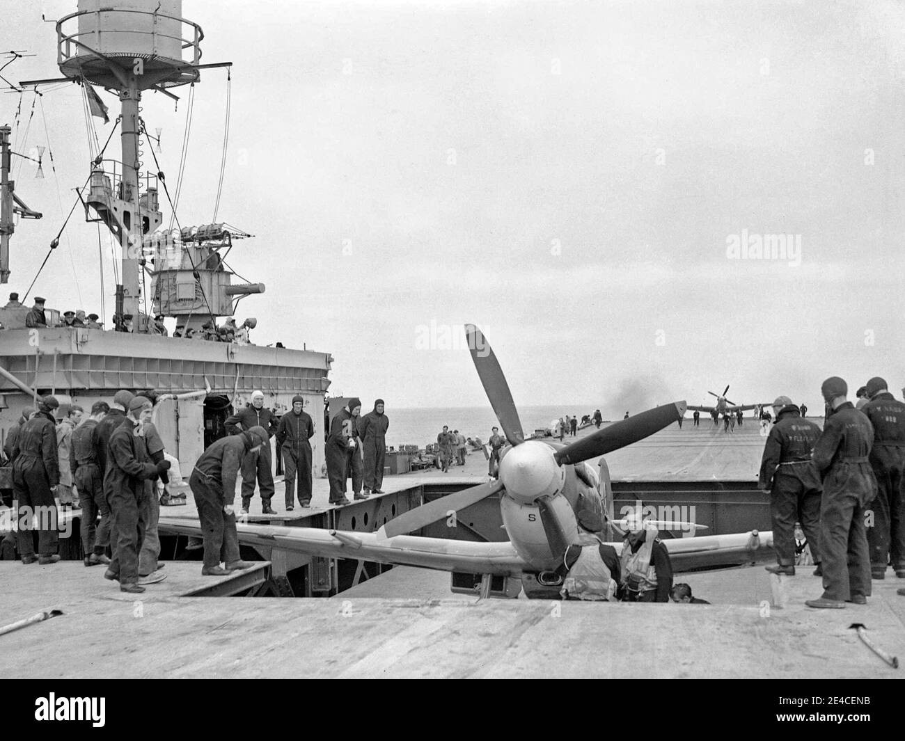 A Supermarine Seafire being brought up on a lift to the flight deck of HMS Furious. Another aircraft can be seen at the far end of the flight deck, 1944 Stock Photo