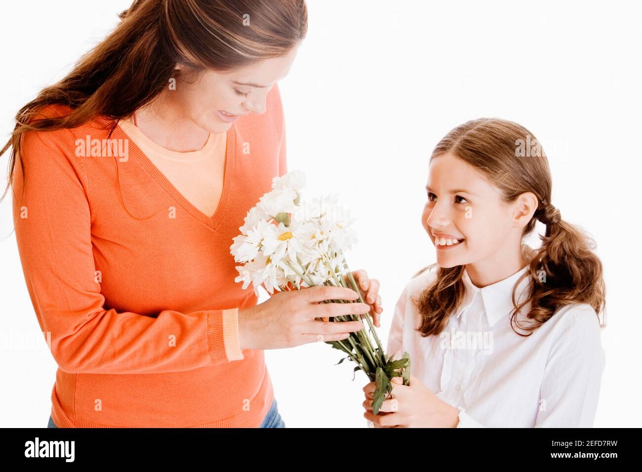 Close-up of a girl giving her mother a bunch of flowers Stock Photo