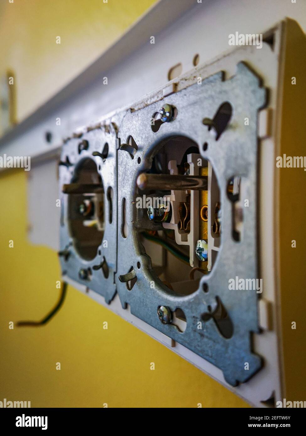 Power plug socket without cover in old abandoned hospital Stock Photo