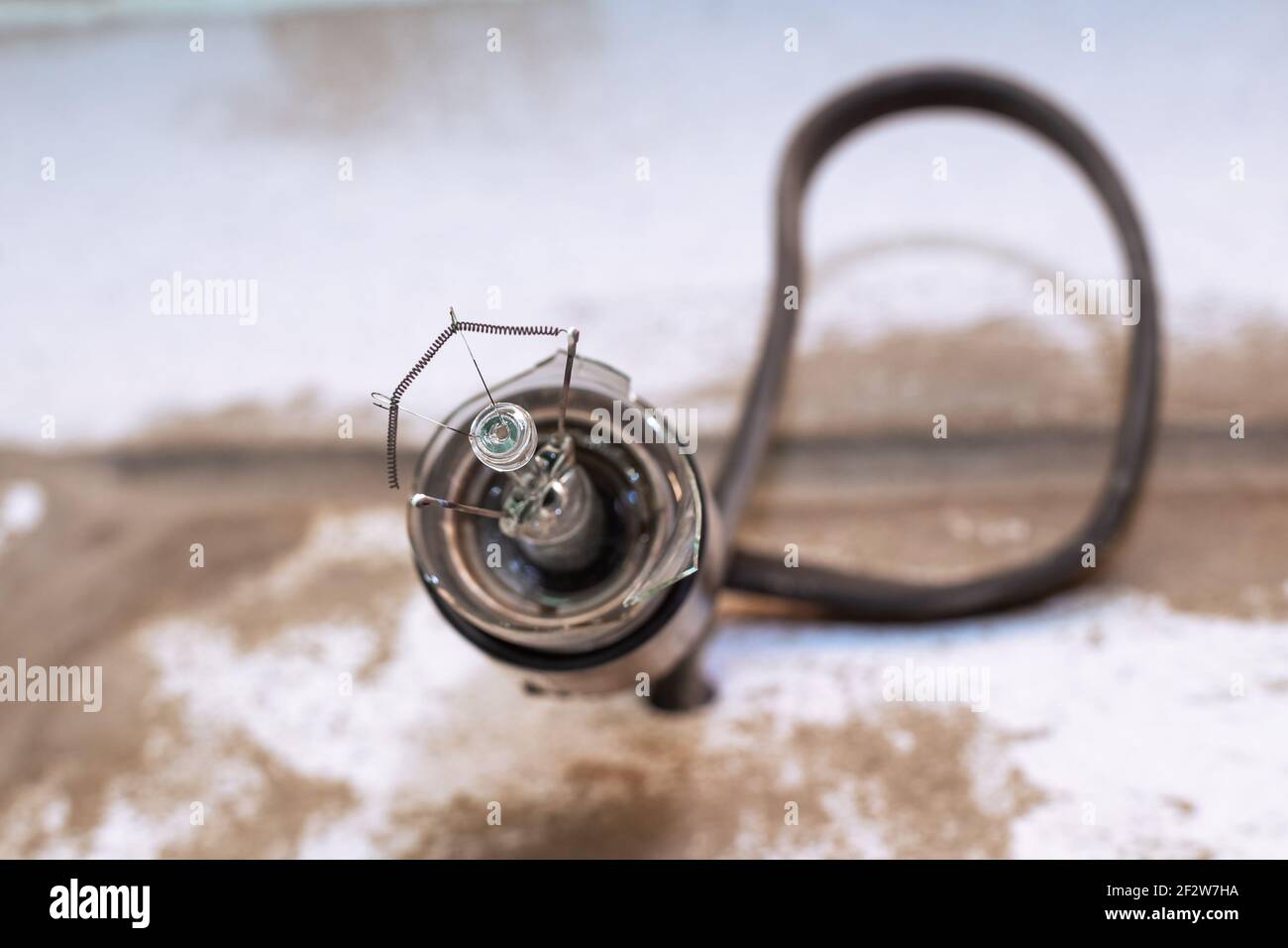 an exploded light bulb in an electric socket close-up. Electricity concept, lighting problems. Stock Photo