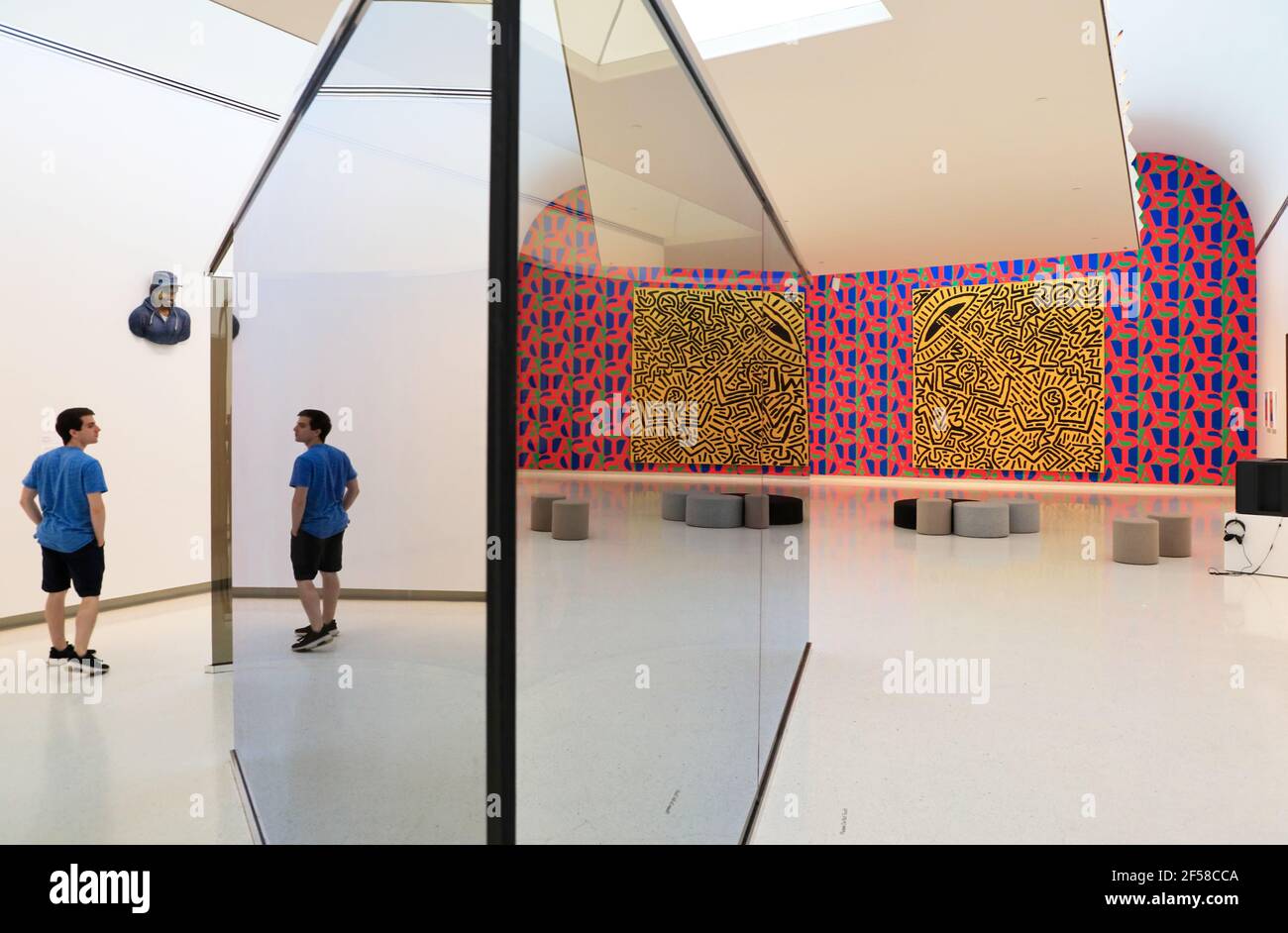 A visitor with Untitled (1981) by New York graffiti artist Keith haring in Carnegie Museum of Art.Pittsburgh.Pennsylvania.USA Stock Photo