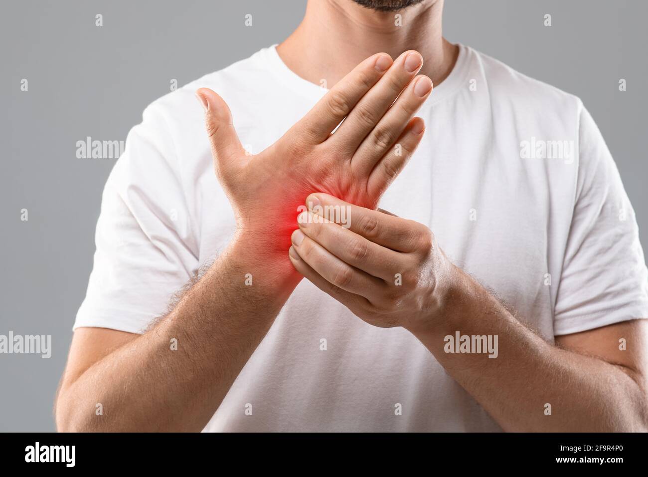 Unrecognizable man scratching itch on his hand Stock Photo