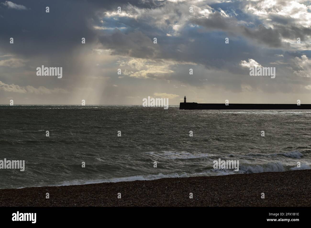 Newhaven Harbour Arm seen from Seaford Beach Stock Photo