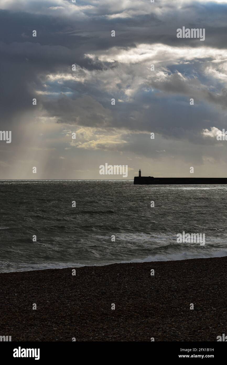 Newhaven Harbour Arm seen from Seaford Beach Stock Photo