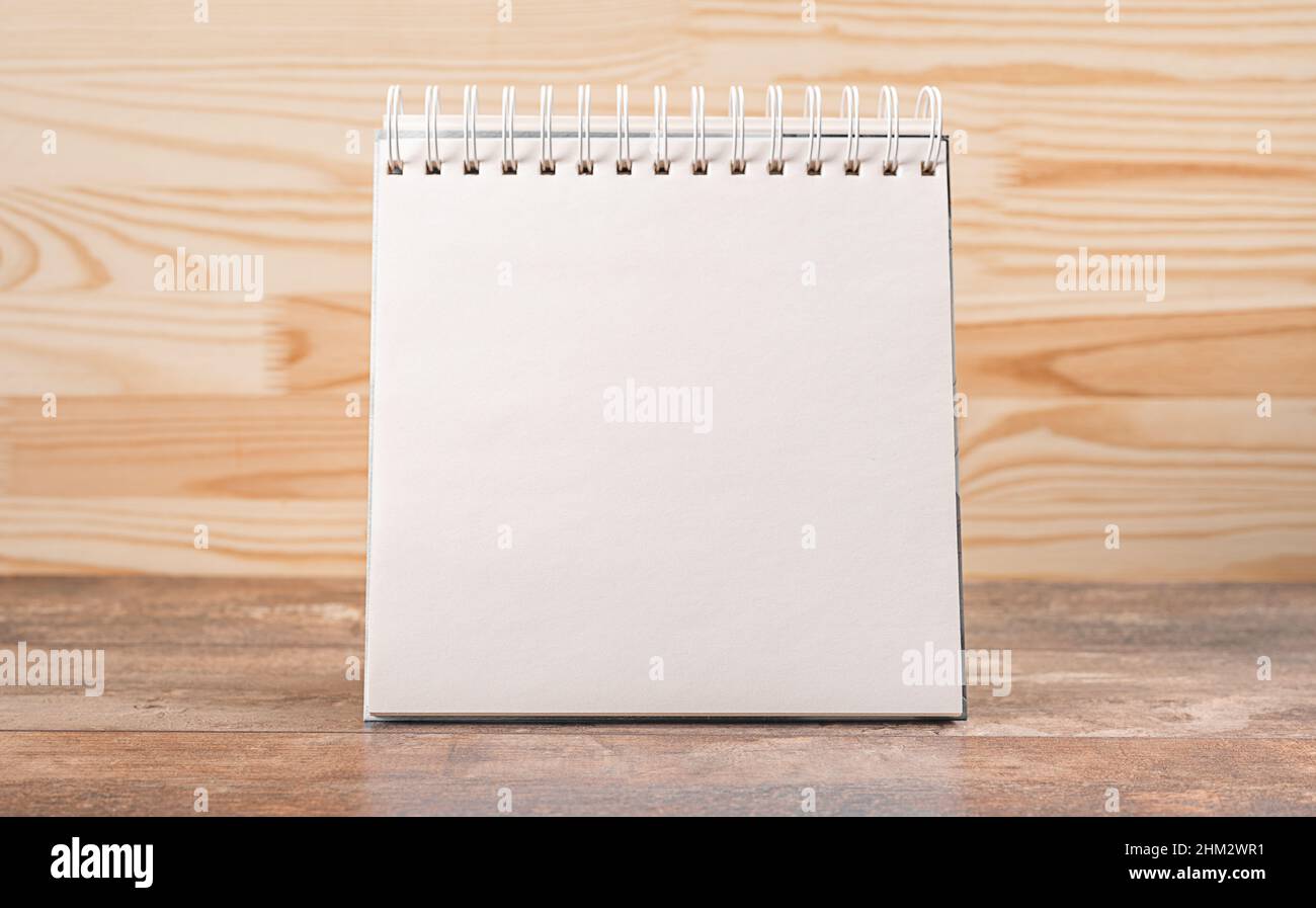 Blank notepad mockup on wooden background. Blank of brochure is on a wooden desk. Template for your design. Calendar desk mockup Stock Photo