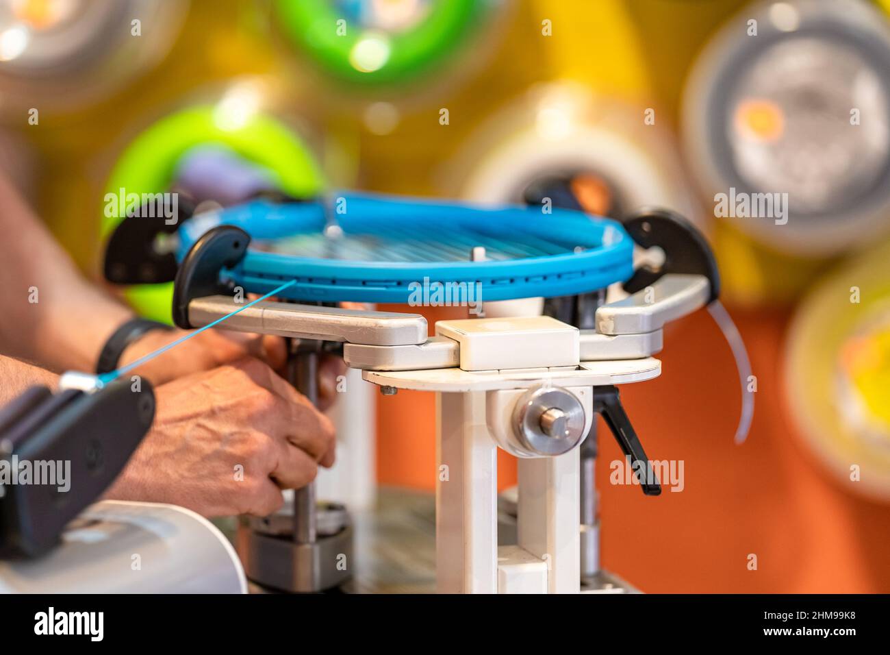 manual stringing of a tennis racket in service Stock Photo