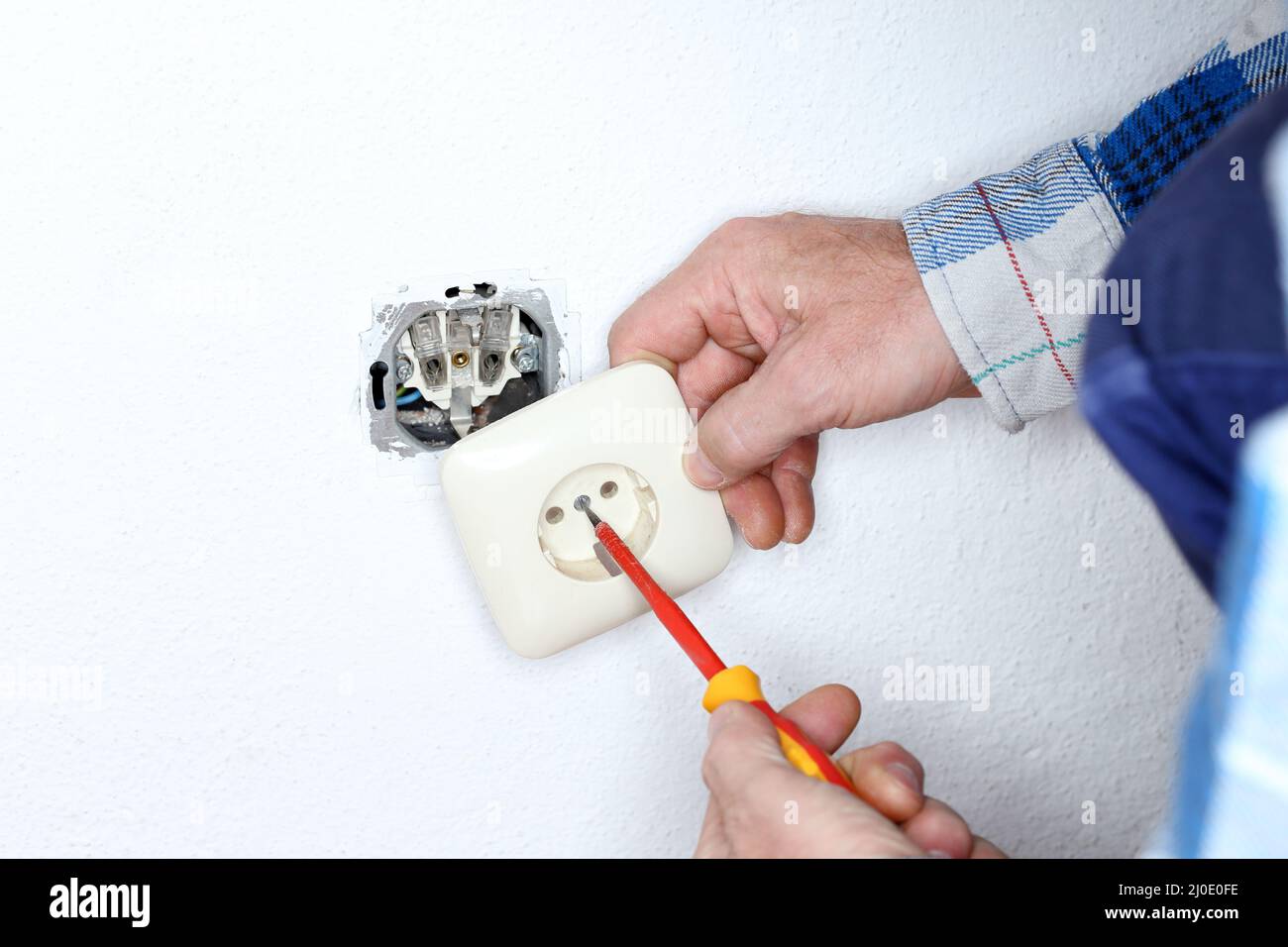 Mounting a wall socket Stock Photo