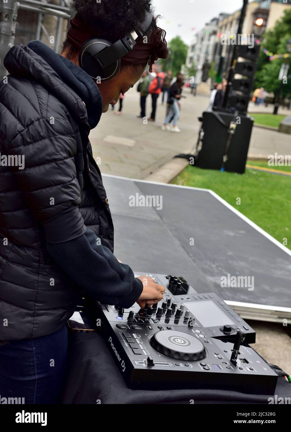 DJ using Pioneer sound mixing deck at outdoor event Stock Photo