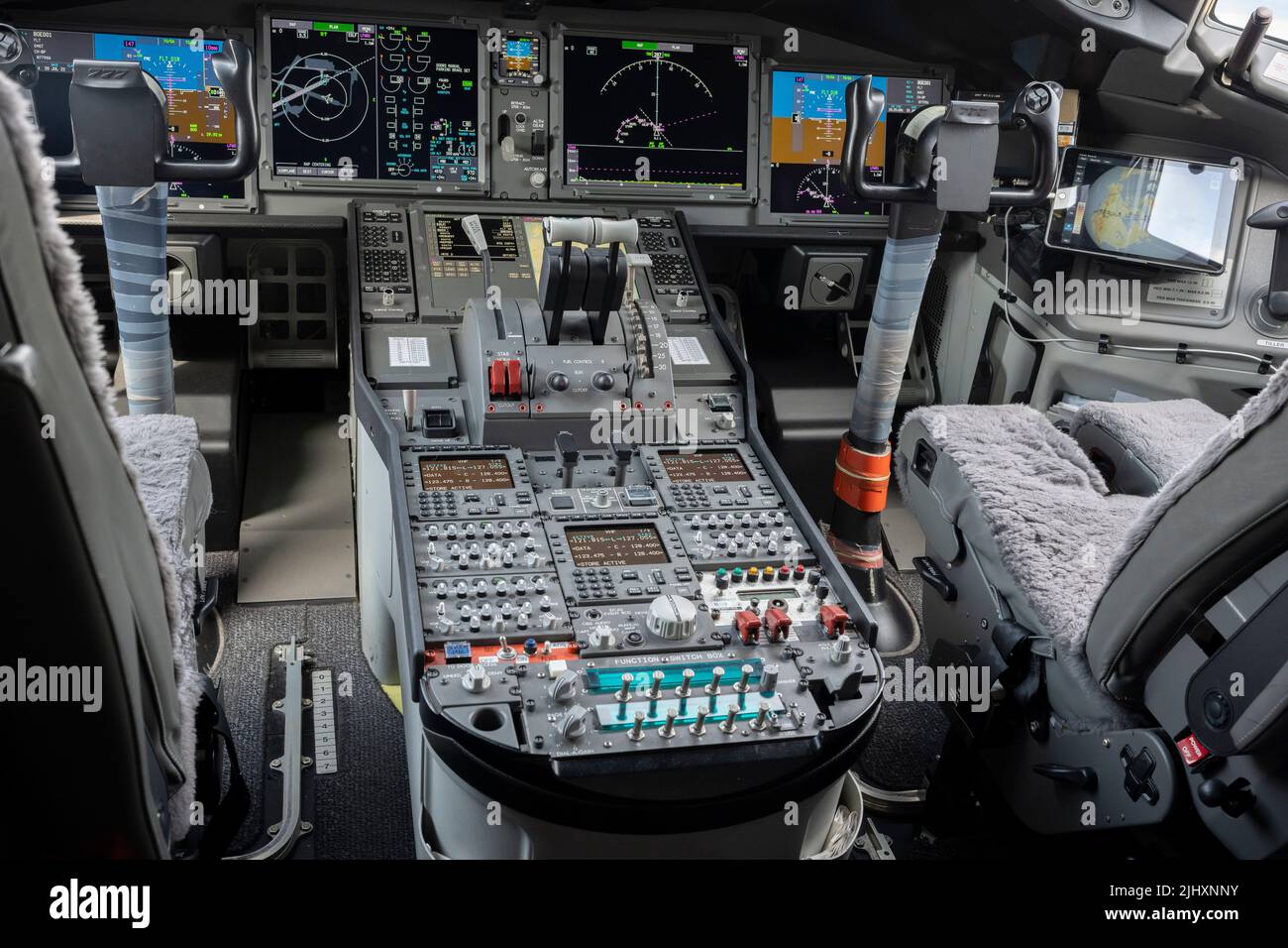 The instruments and screens in the cockpit of a Boeing 777X jet airliner, at the Farnborough Airshow, on 20th July 2022, at Farnborough, England. As a result of the fatal accidents and grounding of the 737 Max fleet around the world, Boeing is now recovering from a financial downturn. Stock Photo