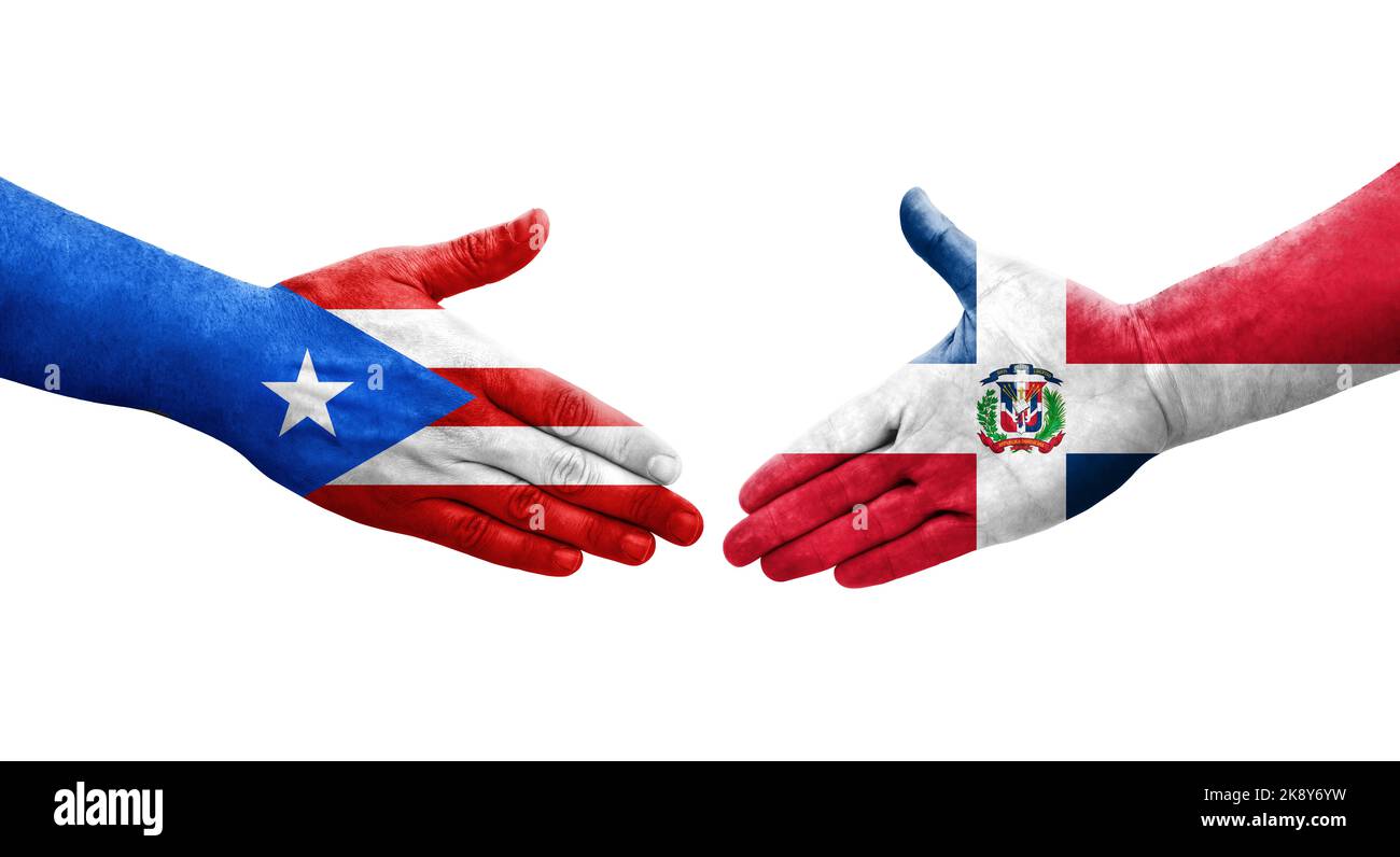 Handshake between Dominican Republic and Puerto Rico flags painted on hands, isolated transparent image. Stock Photo