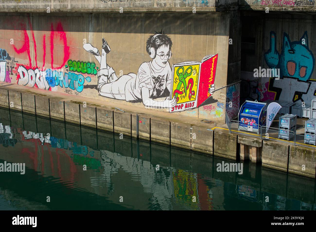 Street art of a woman with a reference to Keith Haring´s stop aids artwork Stock Photo