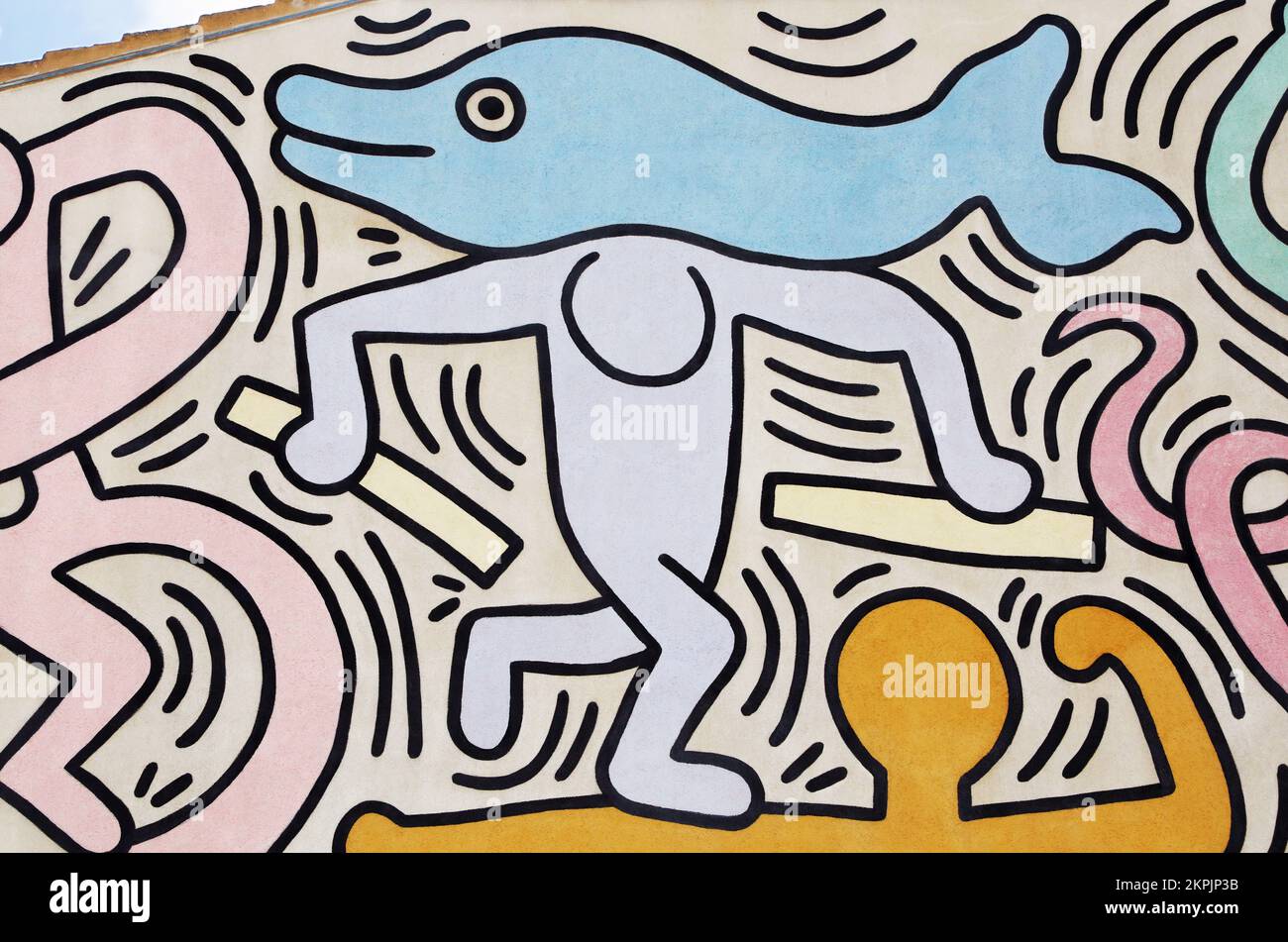 Man carrying a dolphin painted by Keith Haring in Pisa. Detail from a mural named Tuttomondo created outdoor in 1989. Stock Photo