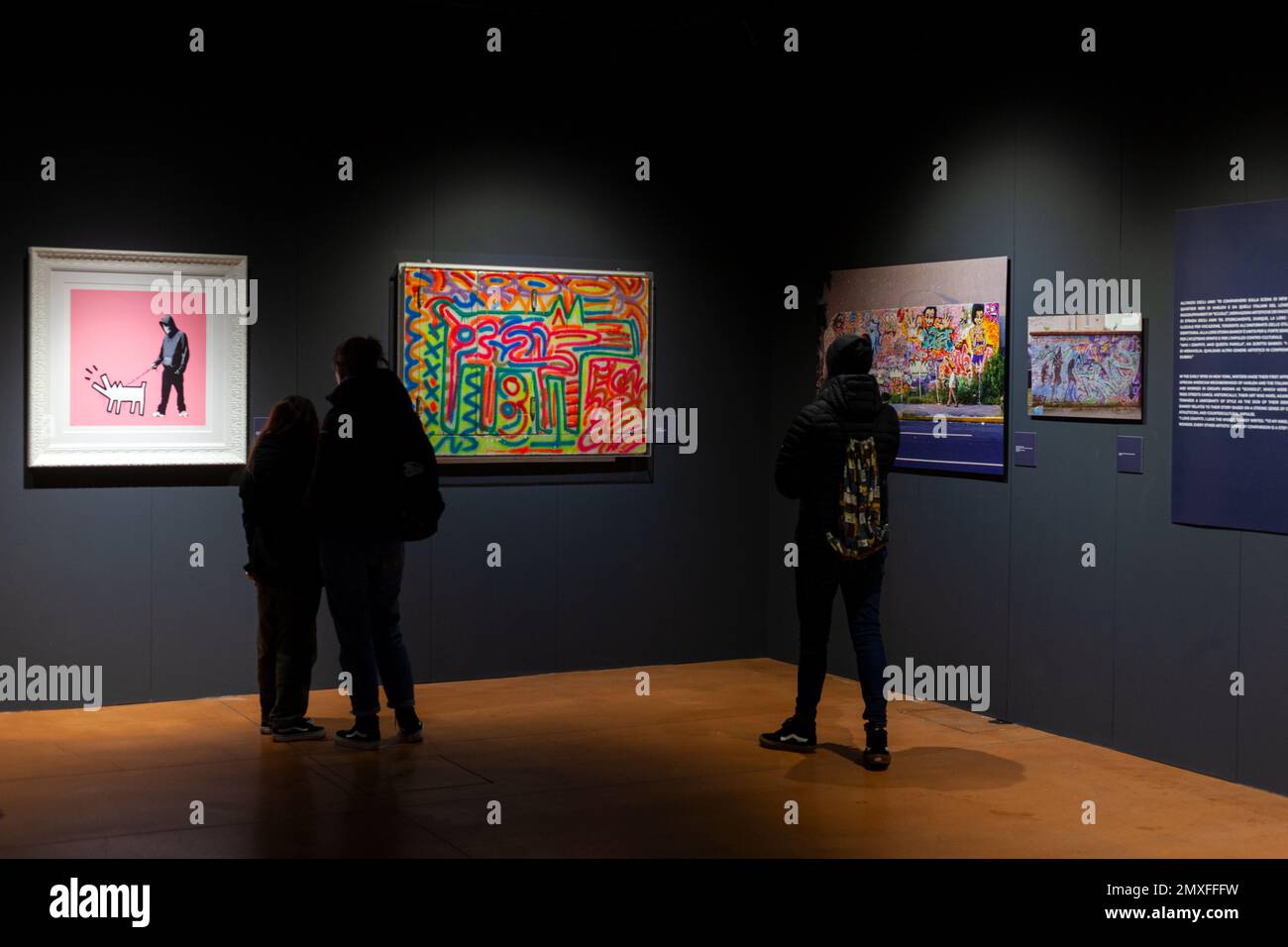 Trieste, Italy - January 21, 2023: People looking the Keith Haring and Bansky artworks. Exposition titled The Great Communicator Banksy, Salone degli Stock Photo