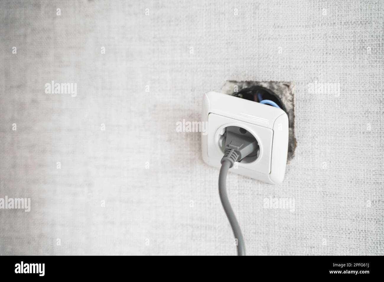 Dangerous bad,broken socket,plug in bathroom,falling out of wall. Outlet installation in old apartment. Poor electrical wire,repair.Terrible do-it-you Stock Photo